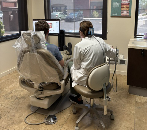 Dentist reviewing treatment options with a patient in the operatory, covered by insurance and financing in Surprise